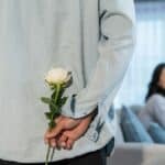 flores para o Dia da Mulher representadas por uma rosa branca entregue em gesto simples e respeitoso